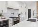 Bright kitchen featuring white cabinets, stainless steel appliances, and quartz countertops at 144 Sardis Ln, Charlotte, NC 28270