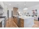 Open kitchen with a large island, modern appliances, and hardwood floors at 144 Sardis Ln, Charlotte, NC 28270