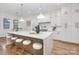 Bright kitchen featuring a large waterfall island with seating, modern appliances, and pendant lighting at 144 Sardis Ln, Charlotte, NC 28270