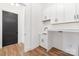 Well-lit laundry room with white cabinets, a sink, and ample counter space at 144 Sardis Ln, Charlotte, NC 28270