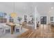 Bright, open-concept living space, showcasing hardwood floors, a dining area and fireplace for a welcoming atmosphere at 144 Sardis Ln, Charlotte, NC 28270
