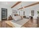 Spacious main bedroom with hardwood floors, modern chandelier, and a seating area for relaxation at 144 Sardis Ln, Charlotte, NC 28270