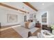 Spacious main bedroom with hardwood floors, exposed beams, and ample natural light at 144 Sardis Ln, Charlotte, NC 28270