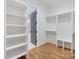 Spacious walk-in closet with custom shelving and natural hardwood flooring at 144 Sardis Ln, Charlotte, NC 28270