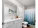 Clean and bright bathroom with a large mirror, vanity, and a shower with a blue curtain at 1461 Forkhorn Dr, Monroe, NC 28110