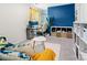 Cozy bedroom featuring blue accent wall, stylish décor and a dedicated workspace for comfort and productivity at 1461 Forkhorn Dr, Monroe, NC 28110