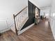 Inviting foyer featuring hardwood floors, staircase, and decorative console table leading into a living space at 1461 Forkhorn Dr, Monroe, NC 28110