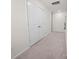 Bright hallway with neutral carpet and white double doors, offering a clean and simple transition space at 1461 Forkhorn Dr, Monroe, NC 28110