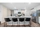 Bright kitchen with a quartz-topped island, modern appliances, and lots of natural light at 1461 Forkhorn Dr, Monroe, NC 28110