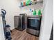 Modern laundry room featuring stainless steel washer, dryer, and wire shelving at 1461 Forkhorn Dr, Monroe, NC 28110