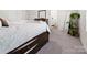 Cozy bedroom with a large bed, dresser, and a view into the en-suite bathroom for easy access at 1461 Forkhorn Dr, Monroe, NC 28110