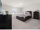 Spacious bedroom with a large window, comfortable bed, and dark wood furnishings, creating a serene retreat at 1461 Forkhorn Dr, Monroe, NC 28110