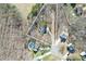 Aerial view of a property with a home, pool, driveway, and surrounding wooded area at 1601 Rosegate Ln, Stanfield, NC 28163