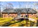 A spacious backyard deck with seating and grill, surrounded by mature trees at 1601 Rosegate Ln, Stanfield, NC 28163