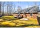 Large backyard featuring a deck, mature trees, and well-maintained lawn at 1601 Rosegate Ln, Stanfield, NC 28163