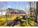 Spacious backyard with a play set, mature trees, and lush green grass at 1601 Rosegate Ln, Stanfield, NC 28163