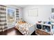 Well-lit bedroom featuring hardwood floors, a bright window, and a playful lion-themed bedspread at 1601 Rosegate Ln, Stanfield, NC 28163