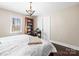 Bedroom featuring a king bed, hardwood floors, natural lighting, and a spacious closet at 1601 Rosegate Ln, Stanfield, NC 28163