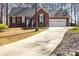 Charming brick home with a well-maintained lawn and long driveway leading to a two-car garage at 1601 Rosegate Ln, Stanfield, NC 28163