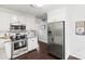 Modern kitchen showcasing stainless steel appliances and white cabinetry with granite counters at 1601 Rosegate Ln, Stanfield, NC 28163