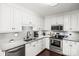 Modern kitchen featuring stainless steel appliances, white cabinetry, and granite countertops at 1601 Rosegate Ln, Stanfield, NC 28163