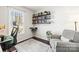 Bright living room featuring a large window, bookshelf, cozy chair and modern decor at 1601 Rosegate Ln, Stanfield, NC 28163