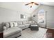 Bright living room features a large sectional couch, a patterned rug, and an arched window at 1601 Rosegate Ln, Stanfield, NC 28163