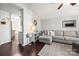 Bright living room with access to a dining space, featuring a sectional couch and a patterned rug at 1601 Rosegate Ln, Stanfield, NC 28163