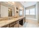 Modern bathroom with granite countertops, dual sinks, and a soaking tub under the bright window at 2027 Gloucester St, Matthews, NC 28104
