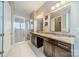 Modern bathroom featuring a glass shower, dual vanities, and bright lighting at 2027 Gloucester St, Matthews, NC 28104