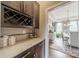 Butler's pantry featuring granite countertops, custom cabinetry, and access to the dining room at 2027 Gloucester St, Matthews, NC 28104