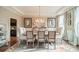 Elegant dining room featuring a coffered ceiling, stylish light fixture, and neutral decor at 2027 Gloucester St, Matthews, NC 28104