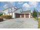 Exterior view of a two-story home with white brick and brown garages at 2027 Gloucester St, Matthews, NC 28104