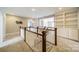 Bright second floor hallway with built-in bookcases, carpet flooring and white stairwell at 2027 Gloucester St, Matthews, NC 28104