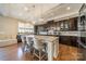 Open kitchen with a large island, pendant lighting, stainless appliances, and barstool seating at 2027 Gloucester St, Matthews, NC 28104