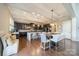 Gourmet kitchen with stainless steel appliances, granite countertops, a large island, and a dining area at 2027 Gloucester St, Matthews, NC 28104
