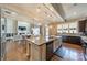 Open kitchen with a large island, stainless appliances and view to the living room and fireplace at 2027 Gloucester St, Matthews, NC 28104