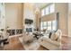 Spacious living room featuring a fireplace, large windows, and soaring ceilings at 2027 Gloucester St, Matthews, NC 28104