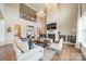 Open living room with soaring ceilings, fireplace, and ample natural light from large windows at 2027 Gloucester St, Matthews, NC 28104