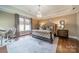 Serene main bedroom featuring tray ceiling, neutral tones, and hardwood floors at 2027 Gloucester St, Matthews, NC 28104
