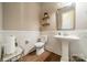Classic powder room with a pedestal sink, wood-look floors, and nice decor at 2027 Gloucester St, Matthews, NC 28104