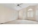 Spacious bedroom boasts lots of natural light with arched window, shutters and ceiling fan at 2027 Meadowood Ln, Charlotte, NC 28211