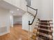Inviting foyer with hardwood floors, staircase runner and view into adjoining room at 2027 Meadowood Ln, Charlotte, NC 28211