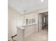 Upstairs hallway with neutral carpet, chandelier, and a view of the windows in the foyer below at 2027 Meadowood Ln, Charlotte, NC 28211