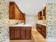 Well-equipped kitchen featuring custom cabinets, stainless steel appliances, and a breakfast bar at 2027 Meadowood Ln, Charlotte, NC 28211