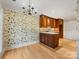 Charming kitchen with custom cabinets and stylish wallpaper at 2027 Meadowood Ln, Charlotte, NC 28211
