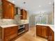 Gourmet kitchen featuring custom cabinets, stainless steel appliances, and charming wallpaper at 2027 Meadowood Ln, Charlotte, NC 28211