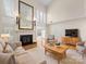 Cozy living room with comfortable seating, fireplace, built-ins, and access to the sunroom at 2027 Meadowood Ln, Charlotte, NC 28211