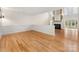 Large, open living room with hardwood floors, fireplace, and an abundance of natural light at 2027 Meadowood Ln, Charlotte, NC 28211