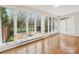 Bright living room features large windows overlooking an outdoor patio with stone flooring and wrought iron furniture at 2027 Meadowood Ln, Charlotte, NC 28211